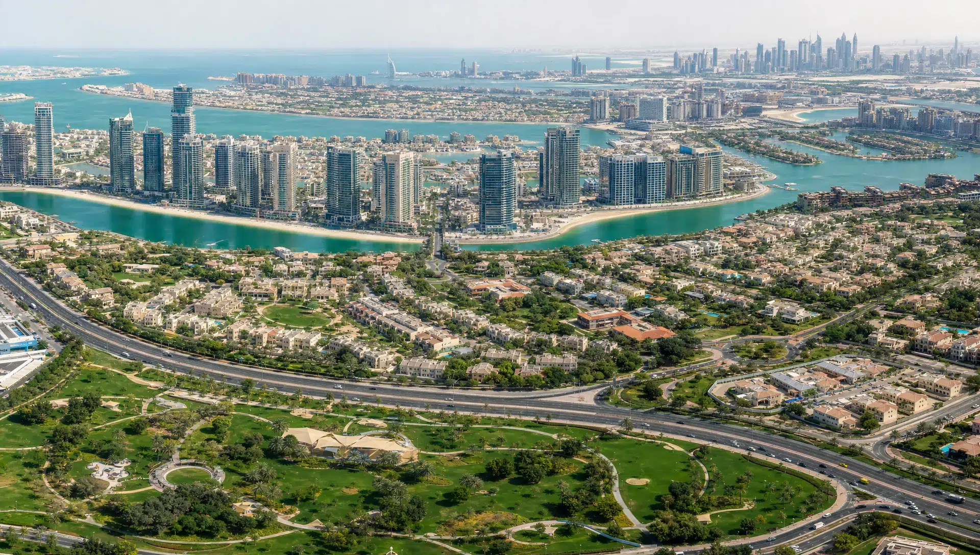 A panoramic view of Dubai residential districts showing waterfront towers, low-rise family communities, green parks, and major roads that connect key property areas.